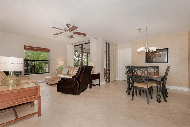 a living room with furniture a dining table and a window