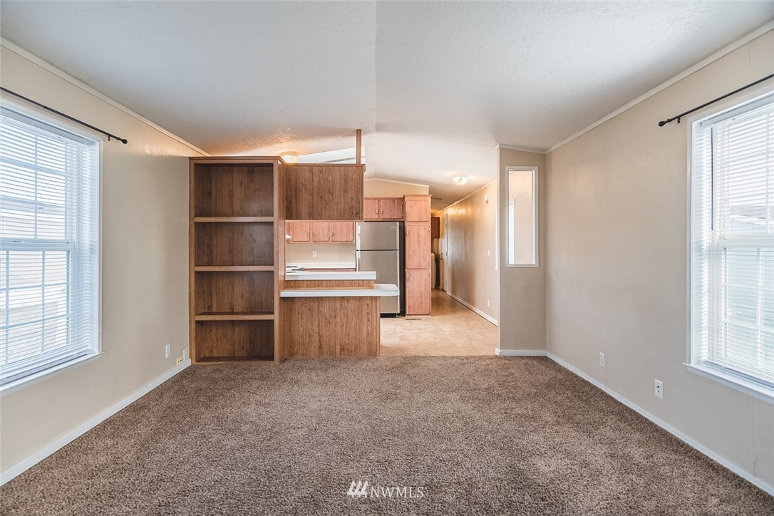 4727 Owens Road Northeast, Unit 20 Moses Lake, WA 98837 - Photo 12 of 36 a view of empty room with wooden floor and windows
