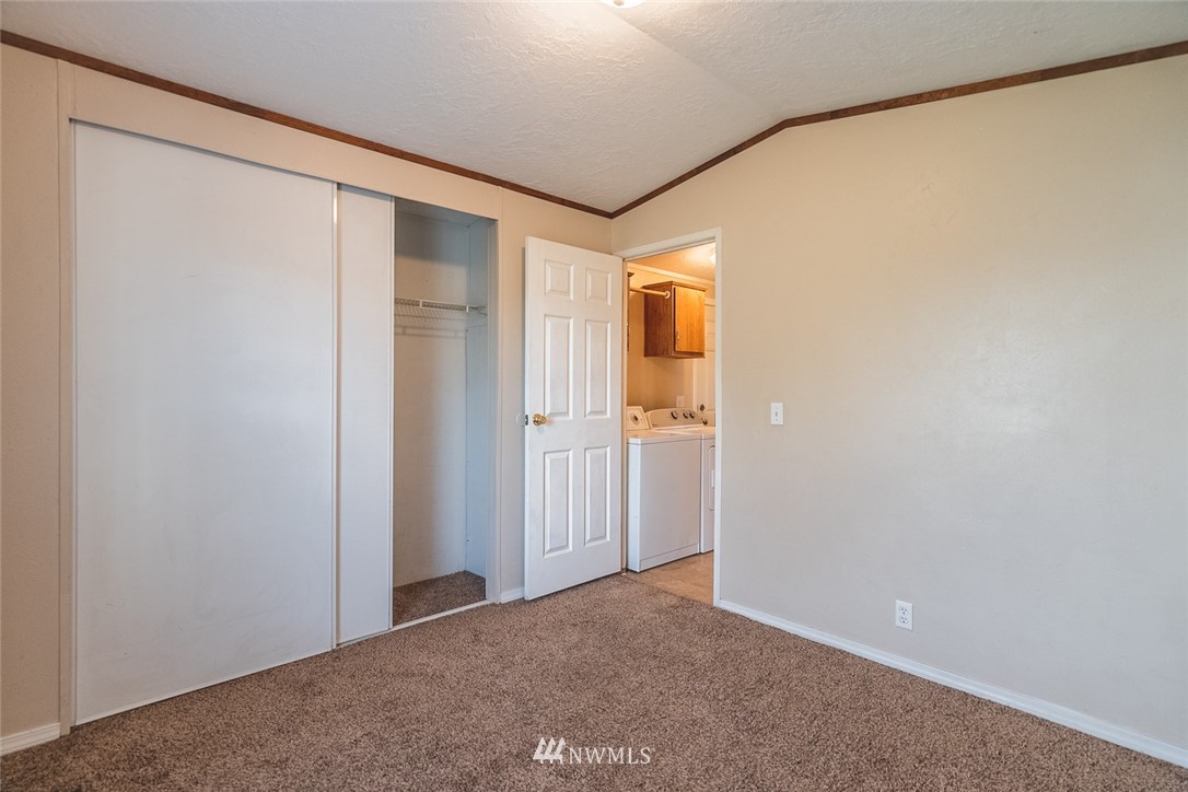 4727 Owens Road Northeast, Unit 20 Moses Lake, WA 98837 - Photo 29 of 36 a view of a big room with closet and wooden floor