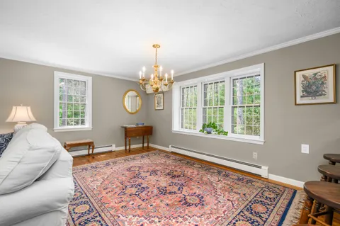 a living room with furniture chandelier and a window