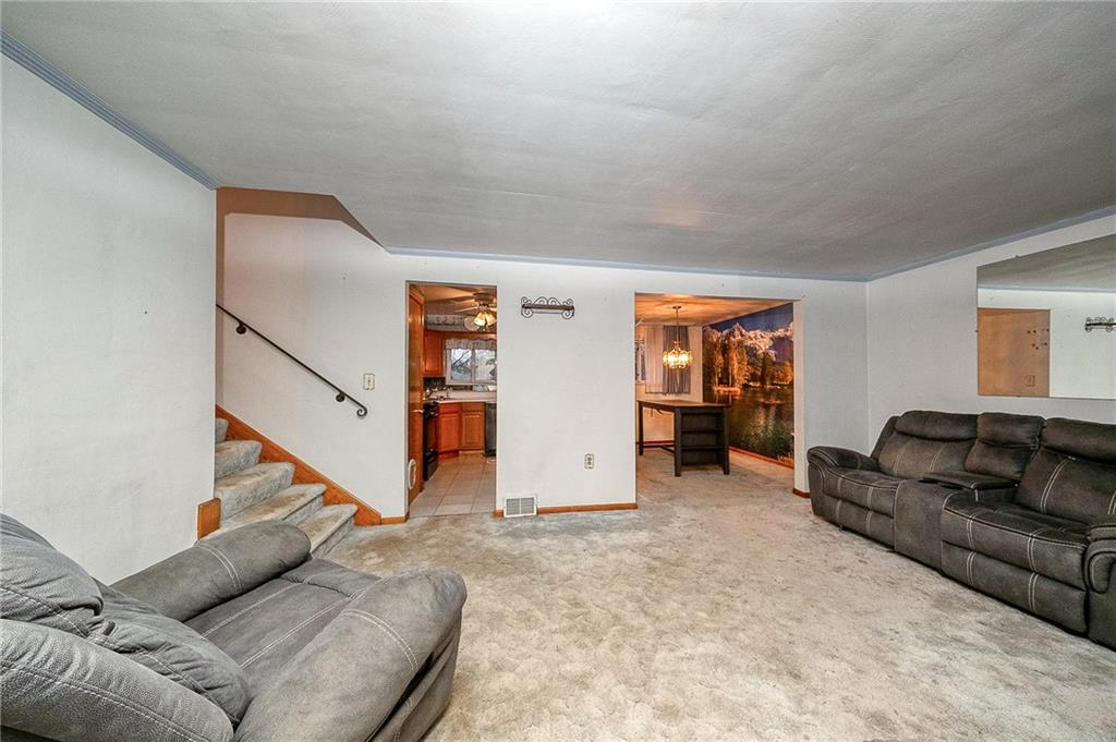 609 Regency Drive Pittsburgh, PA 15239 - Photo 14 of 32 a living room with furniture and stairs