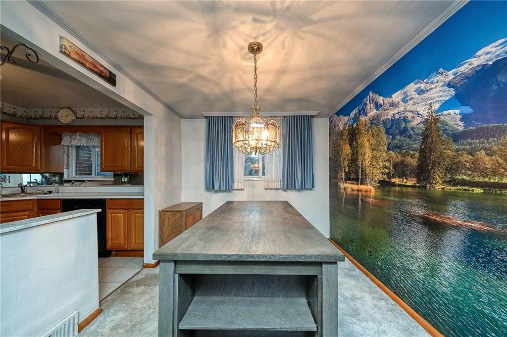 609 Regency Drive Pittsburgh, PA 15239 - Photo 10 of 32 a kitchen with stainless steel appliances granite countertop a stove a sink and a refrigerator