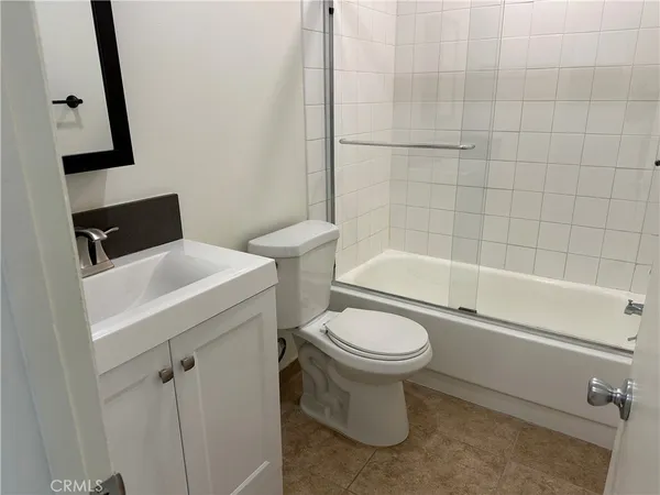 a bathroom with a sink a toilet and bathtub