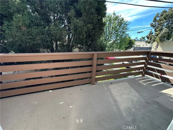 a view of backyard with wooden fence and trees
