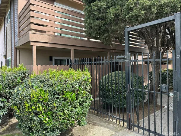 a front view of a house with a tree