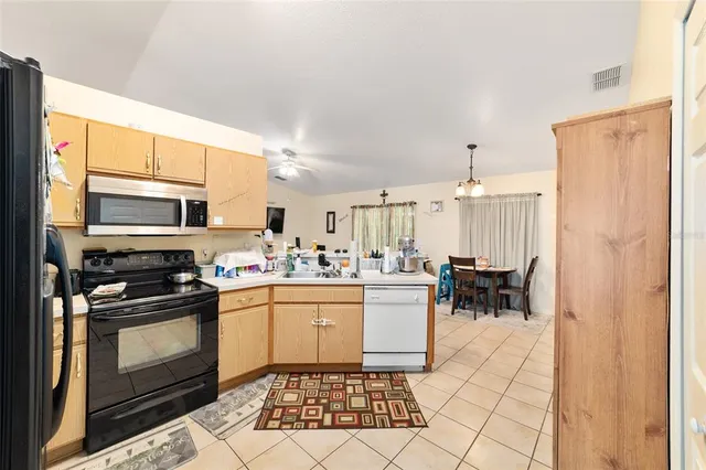 a kitchen with a stove a sink and a microwave