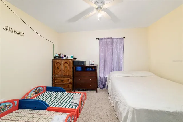 a bedroom with a bed and a dresser