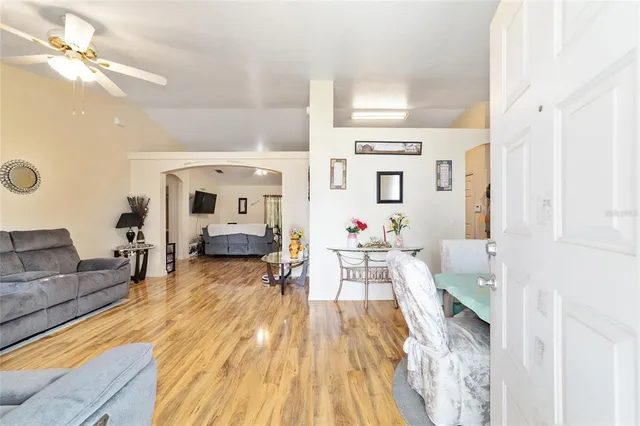 a living room with furniture and wooden floor