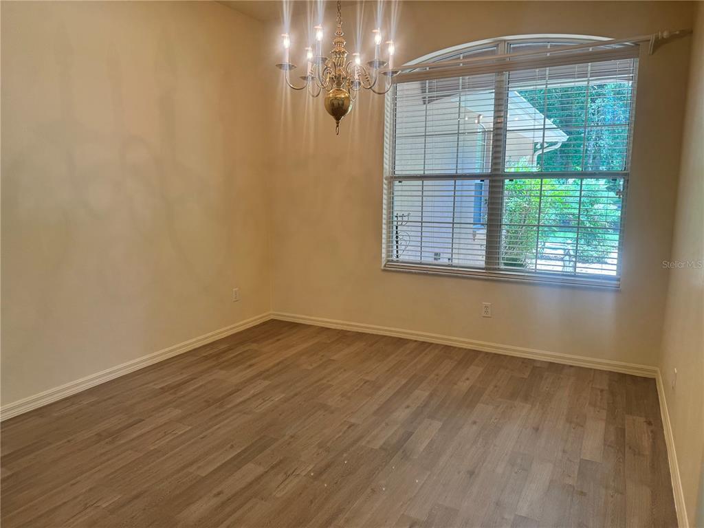 11145 Northwest 17th Court Road Ocala, FL 34475 - Photo 37 of 59 a view of an empty room with wooden floor and a window