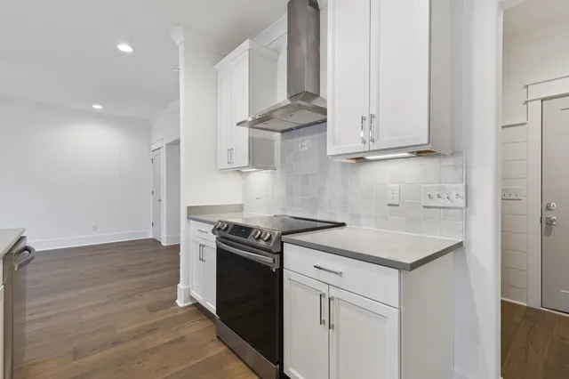 a view of a kitchen with white cabinets and a sink