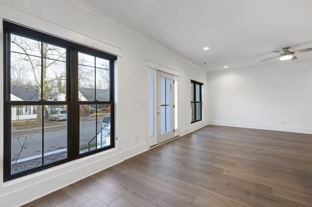 a large kitchen with granite countertop a large counter top a sink stainless steel appliances and cabinets