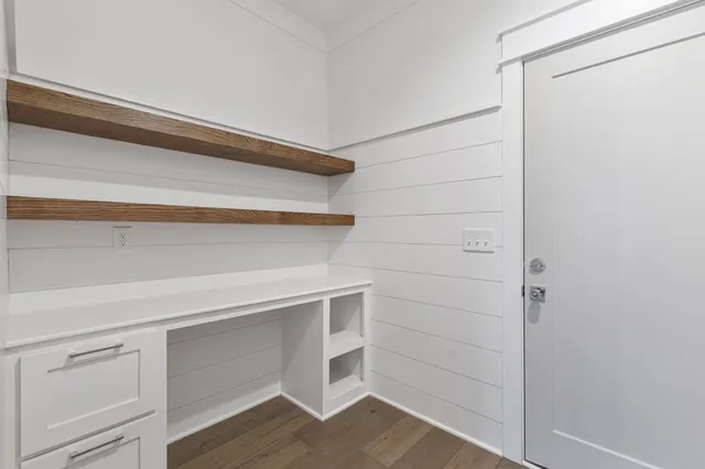 a kitchen with white cabinets and white appliances
