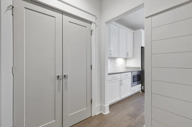 an empty room with windows and fan