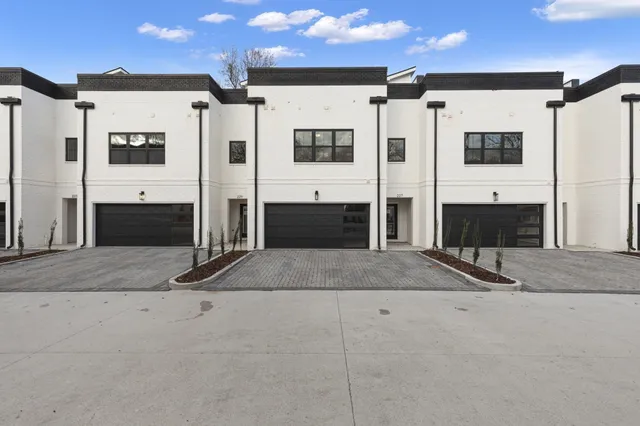 a large kitchen with stainless steel appliances kitchen island granite countertop a refrigerator and a stove