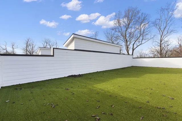 a view of table room with wooden floor chairs and refrigerator