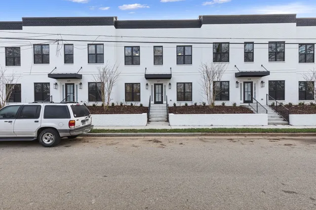 a view of a white building among the street