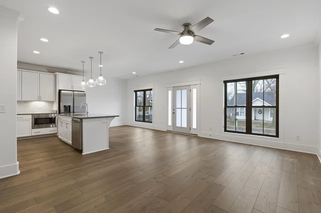 a view of a kitchen with a refrigerator and a ceiling fan