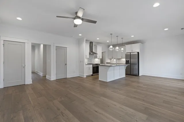 a view of an empty room with wooden floor