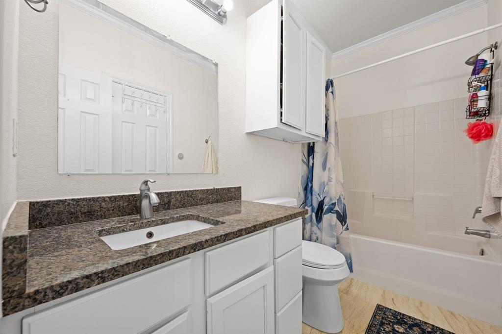 7 St Charles Place Midlothian, TX 76065 - Photo 18 of 27 a bathroom with a granite countertop sink toilet and shower