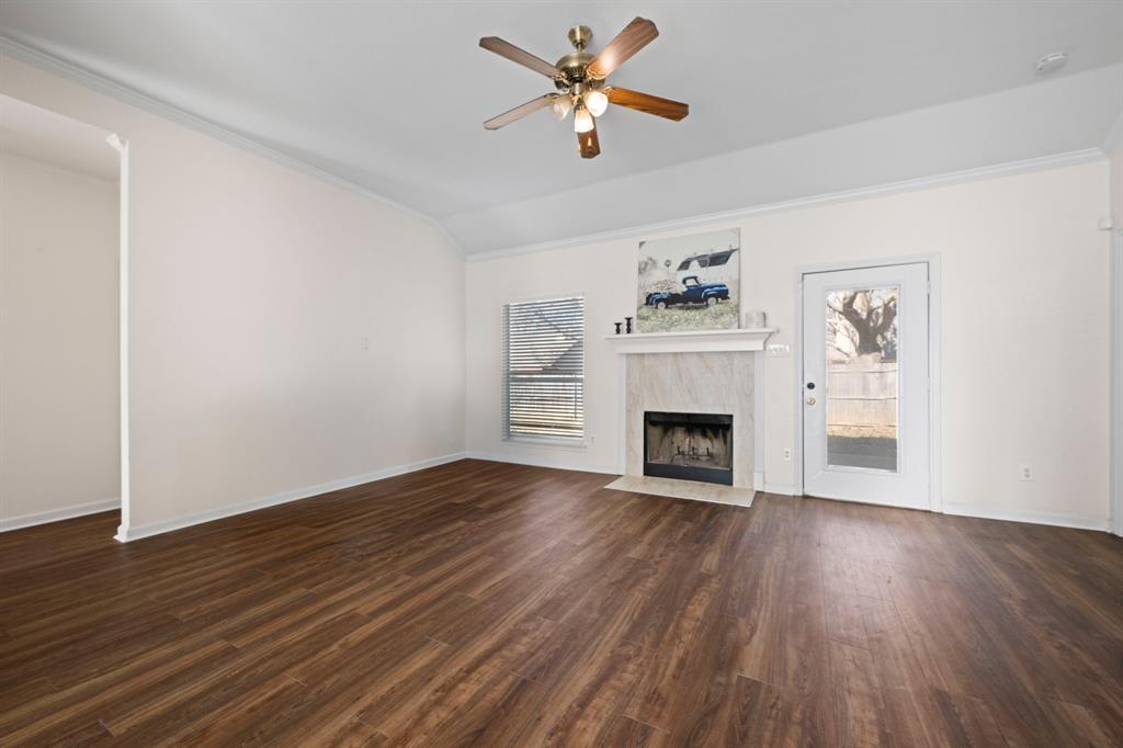 7 St Charles Place Midlothian, TX 76065 - Photo 7 of 27 a view of a livingroom with a fireplace a ceiling fan and wooden floor