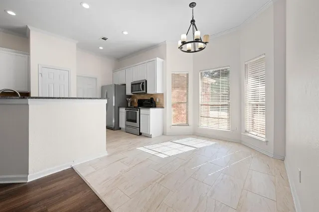 a view of kitchen with sink microwave refrigerator and cabinets