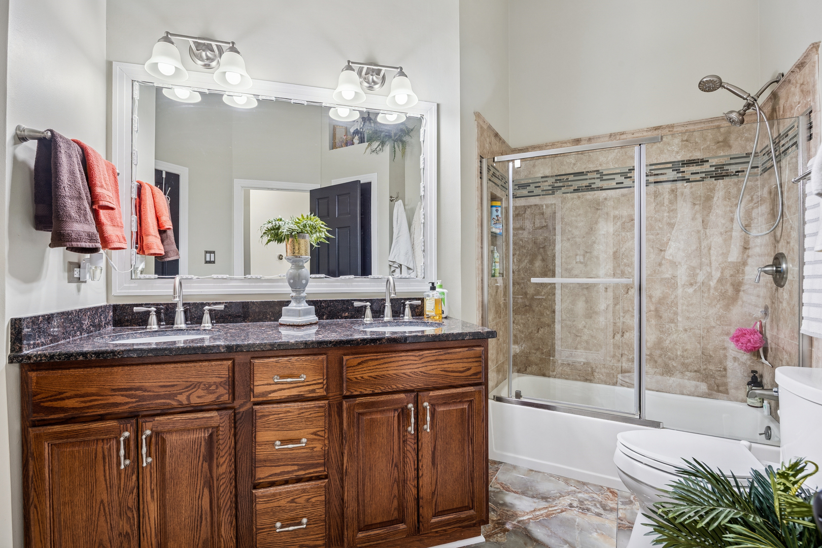 7616 West Saint Francis Road Frankfort, IL 60423 - Photo 11 of 16 a bathroom with a granite countertop sink a large mirror and a shower