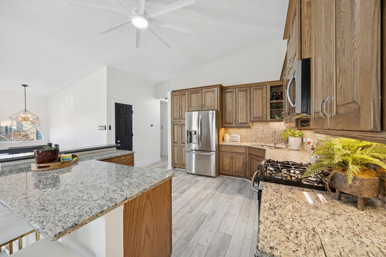 7616 West Saint Francis Road Frankfort, IL 60423 - Photo 4 of 16 a kitchen with stainless steel appliances granite countertop a sink stove and refrigerator