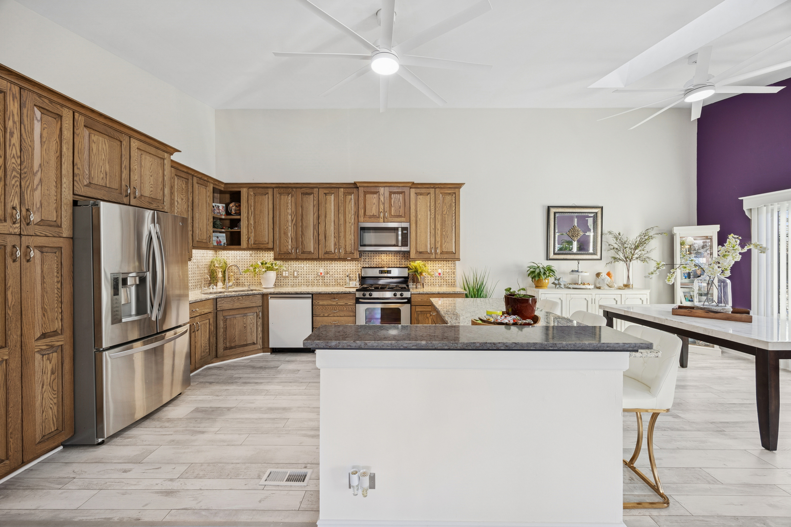 7616 West Saint Francis Road Frankfort, IL 60423 - Photo 5 of 16 a kitchen with stainless steel appliances granite countertop a refrigerator a sink dishwasher a stove with chairs and wooden floor