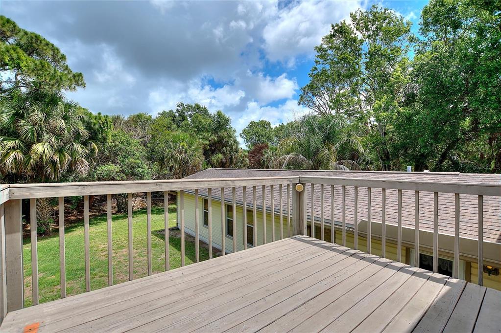 3641 Turtle Mound Road Melbourne, FL 32934 - Photo 50 of 77 a view of balcony with wooden floor and fence