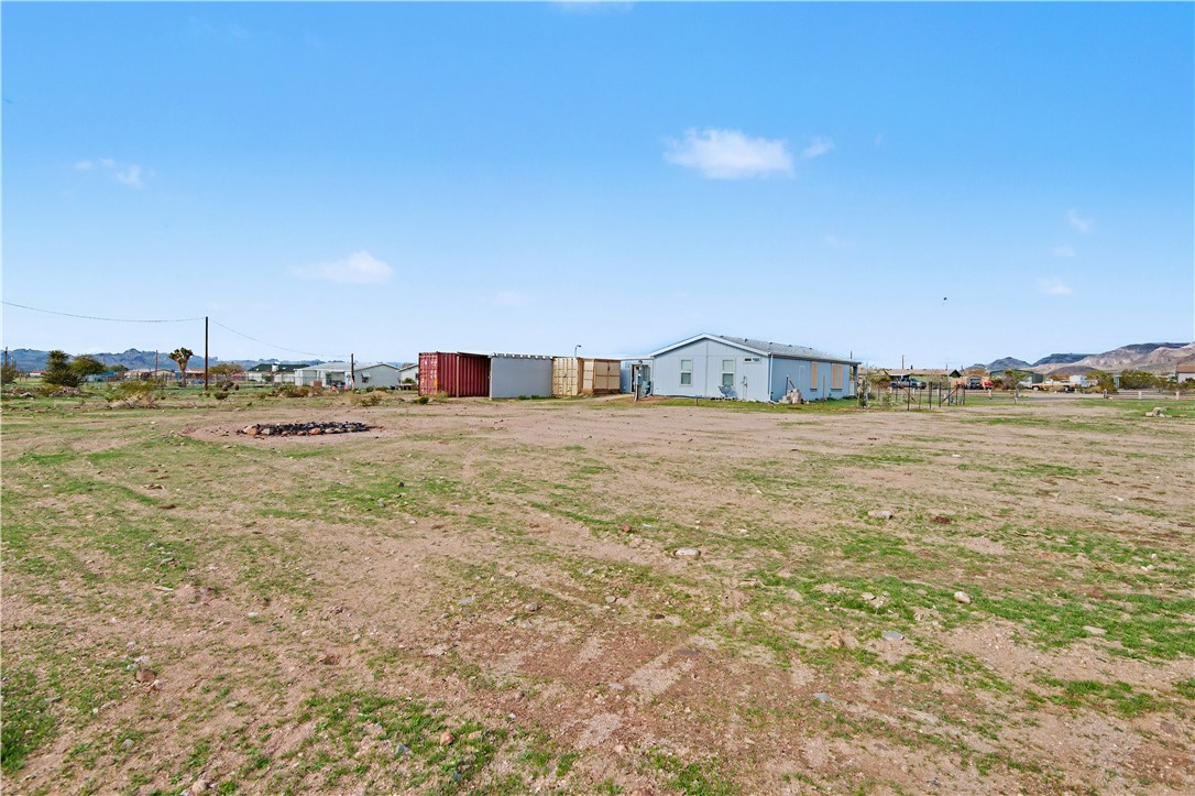 3058 West Carmichael Road Golden Valley, AZ 86413 - Photo 32 of 36 View of yard featuring an outbuilding