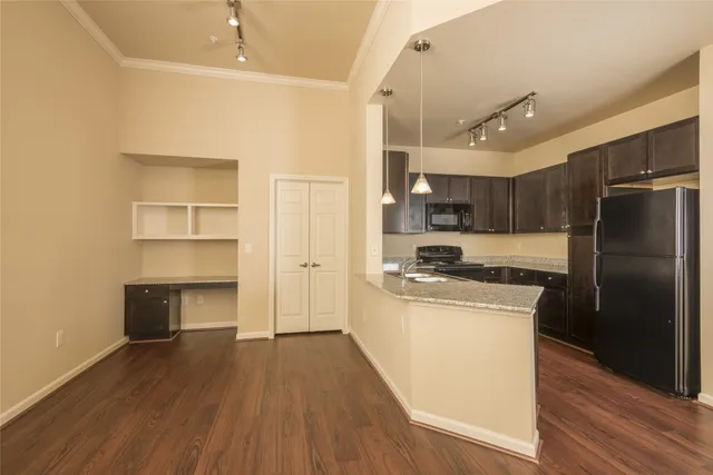 a kitchen with refrigerator cabinets and wooden floor