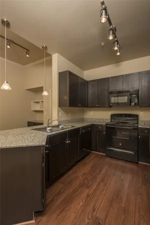 a kitchen with a sink cabinets and stainless steel appliances