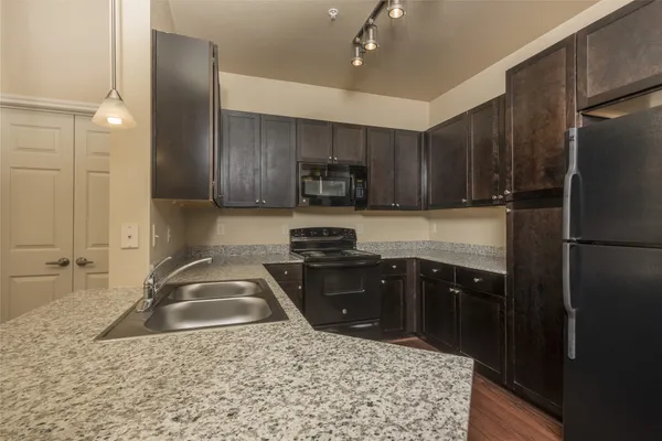 a kitchen with a sink stove and refrigerator