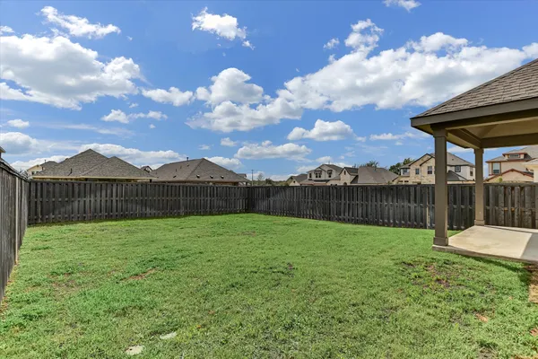 a view of a house with wooden fence