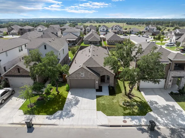 an aerial view of a house with a yard and garden