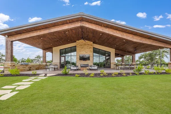 a view of a house with a big yard and sitting area
