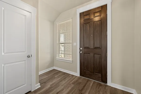 an empty room with windows and closet