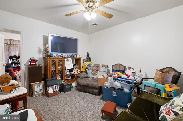 a room with furniture a rug and white walls