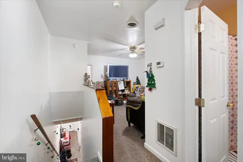 a kitchen with stainless steel appliances a stove a sink dishwasher and white cabinets with wooden floor