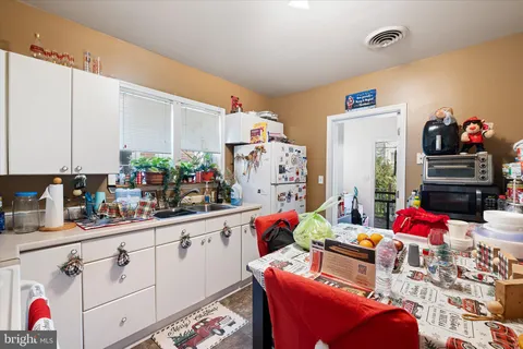 a bathroom with a granite countertop sink a toilet and a mirror