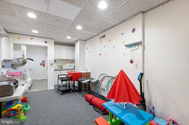 a kitchen with stainless steel appliances granite countertop a sink dishwasher and a refrigerator