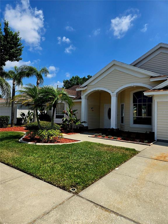 7838 Trail Run Loop New Port Richey, FL 34653 - Photo 1 of 36 a front view of a house with a yard