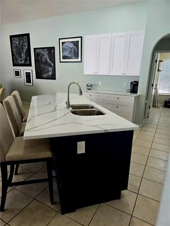 a kitchen with a sink cabinets and wooden floor