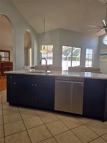 a kitchen with a sink window and cabinets