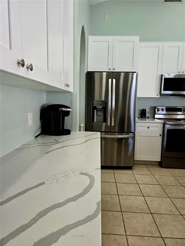 a kitchen with a refrigerator a stove a microwave and cabinets