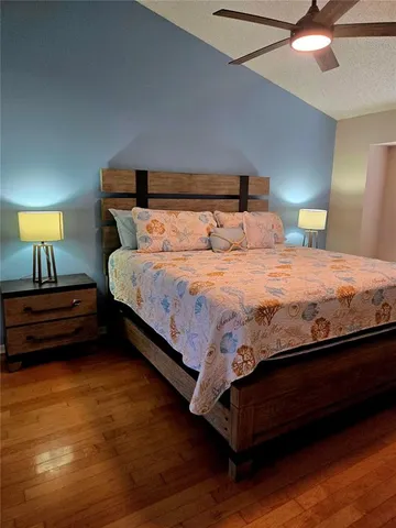 a bedroom with a bed a lamp and a chandelier