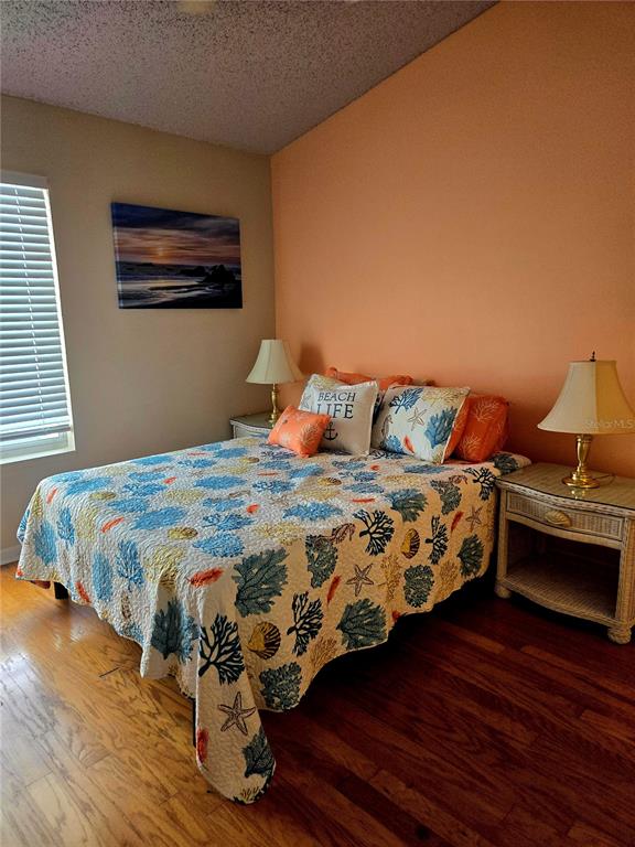 7838 Trail Run Loop New Port Richey, FL 34653 - Photo 24 of 36 a bedroom with a bed and wooden floor