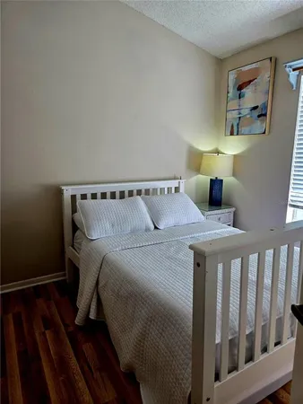 a view of a bedroom with closet and wooden floor