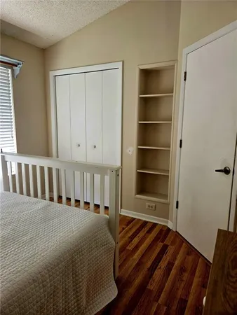 a bathroom with a granite countertop sink and a toilet