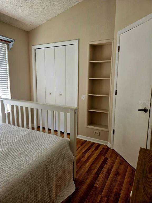 7838 Trail Run Loop New Port Richey, FL 34653 - Photo 27 of 36 a view of a bedroom with closet and wooden floor